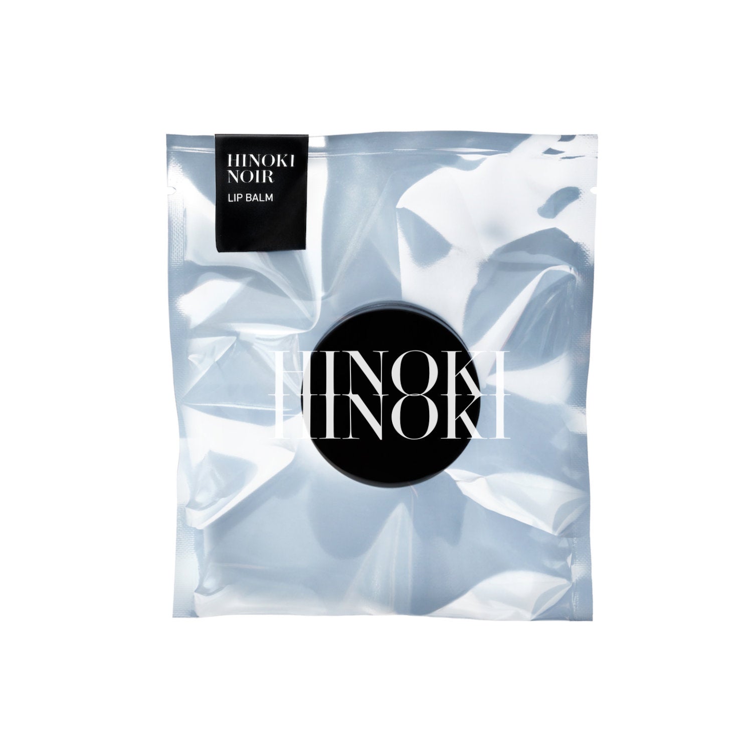 Hinoki Noire lip balm packaging on a white background