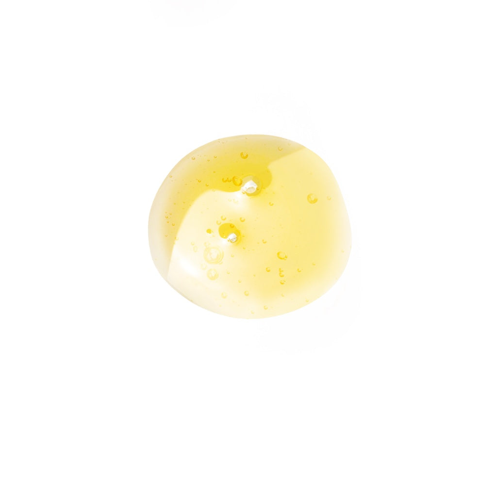 Yellow oil drop on a white background
