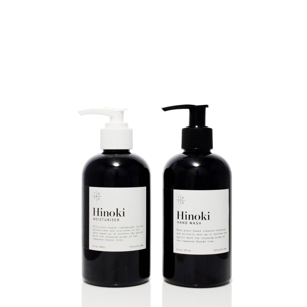 Two black bottles with pump dispensers labeled 'Hinoki' on a white background