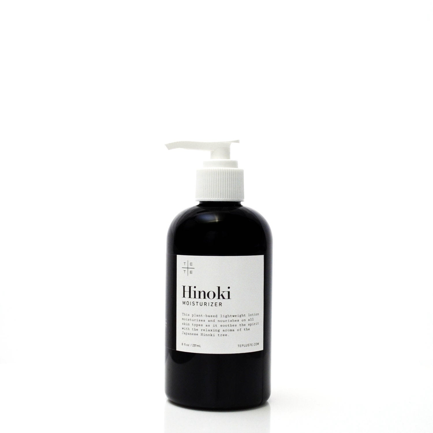 Black bottle of Hinoki moisturizer with a white label on a white background
